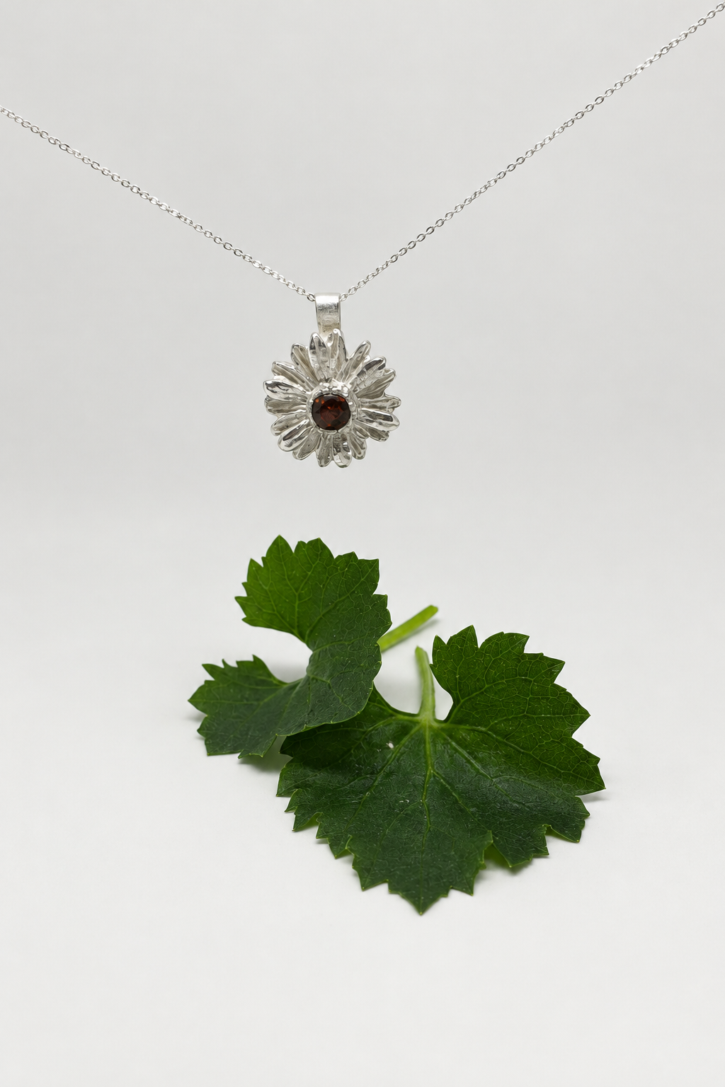 Cleaned background, suspended necklace above leaves
