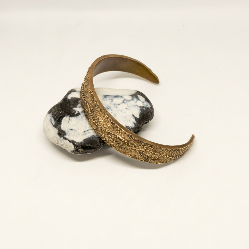 Cleaned bronze cuff styled on stones